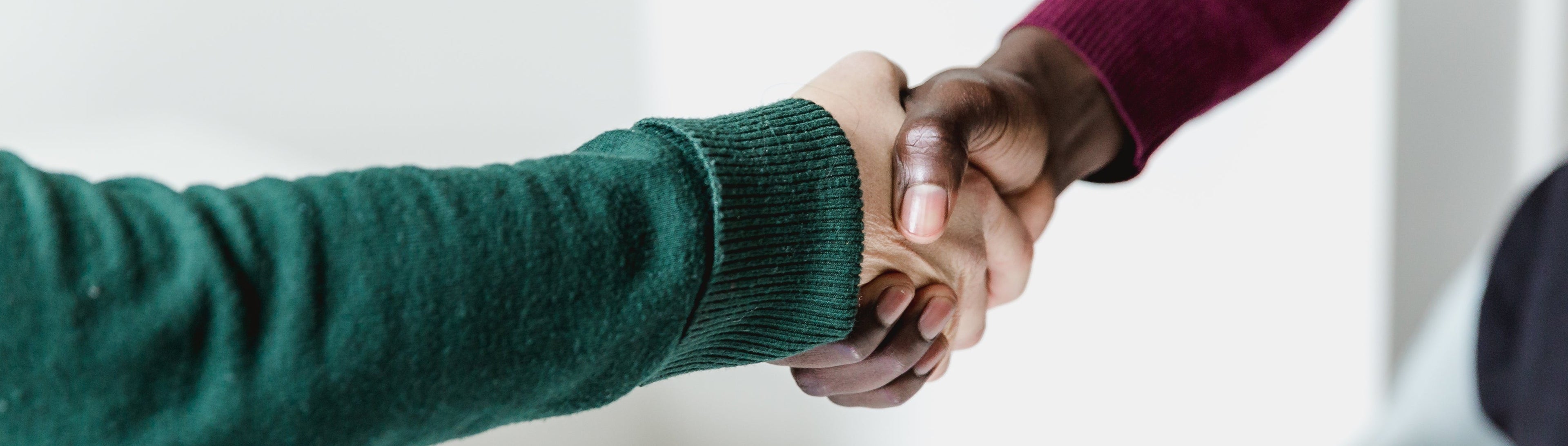 Handshake at a business meeting — careers with Orchard Retail Group